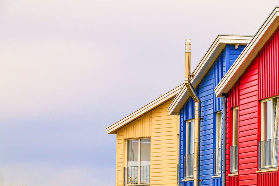 Exterior wall with painted trim and a window frame