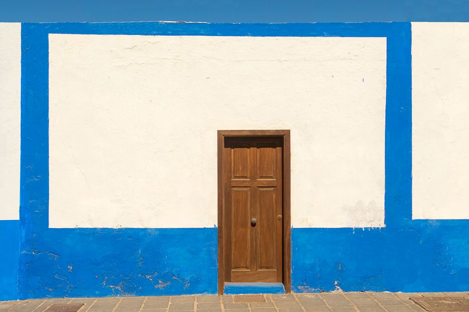 Painted house wall with windows in daylight